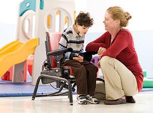 child in Rifton activity chair  